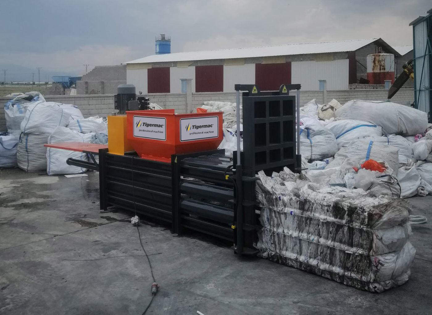 Tigermac bale press producing a finished bale at a recycling facility